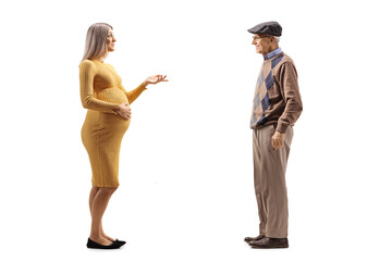 Full length profile shot of a pregnant woman talking to an elderly gentleman