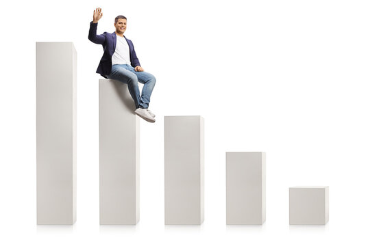 Man in jeans and suit sitting on a bar graph and waving at camera