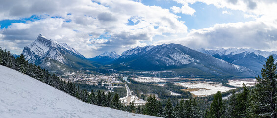 Overlook view Town of Banff in snowy winter season. Snow Capped Mount Rundle, Sulphur Mountain in...