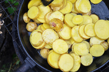 Vegan cuisine. Top view of da sliced potatoes in a pan ready for frying. Fast food concept. Ready to cook background, texture.