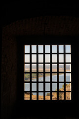View of Juromenha castle with grid window in Alentejo landscape, in Portugal