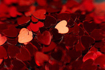 Scattering of small red hearts, beautiful background of hearts for the holiday of valentine