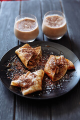 Chocolate pancakes and coffee for breakfast in the sunny morning