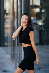 Beautiful woman, summer in city, fitness training on street.