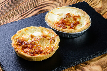 Tartlet pastries. Delicious and healthy range of bakery. hearty tartlets. baked tart pies with cheese, meat, mushroom and dill for sale. Food, gastronomy and pastry concept