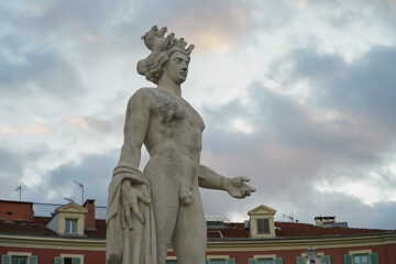 Fototapeta na wymiar The statue of Apollo at Place Massena in Nice. Beautiful evening sky at sunset.