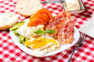 bacon and eggs with avocado and tomato, bread and coffee