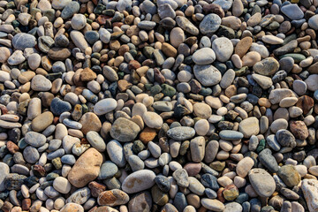 Smooth round pebbles texture background. Pebble sea beach close-up