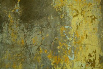 Background texture of cracked concrete wall with remnants of old green paint in a full frame view. This is a lighter version, a darker version is also available in the portfolio