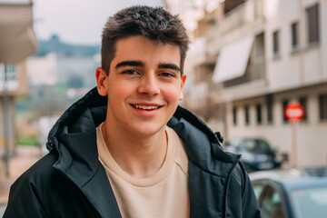 portrait of young male teenager smiling outdoors