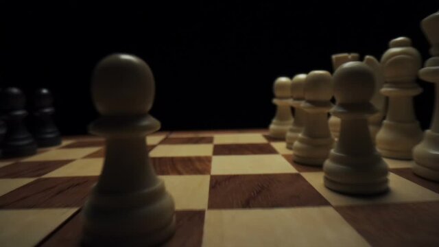 White piece move in chess. Game of chess. Game strategy. Camera travel along the chess pieces. Slow motion
