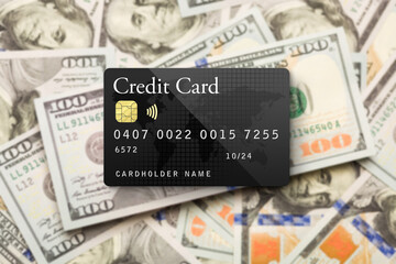 Fototapeta premium Mockup Black Credit Card Resting on One Hundred Dollar Bills Background