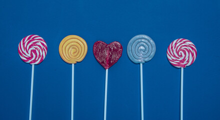 Color lollipops on blue background