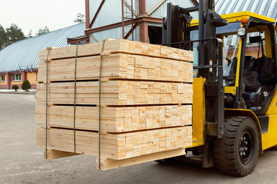 Loader lifts packed lumber for further transportation
