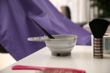 Workplace with bowl of hair dye in beauty salon