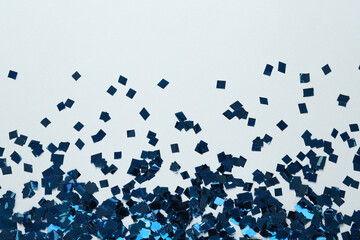 Shiny blue confetti on light grey background, flat lay