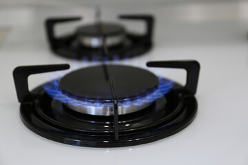 Modern kitchen stove with burning gas, closeup