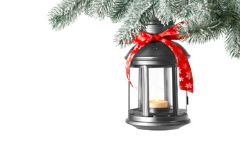 Obraz premium Christmas lantern with candle hanging on snowy fir tree branch against light background. Space for text