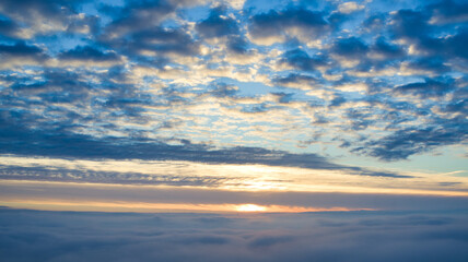 Aerial View of Sunrise over Clouds