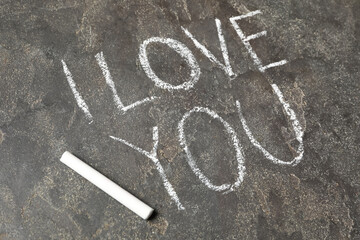 Text I Love You and chalk piece on grey stone background