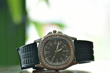 Black wristwatch with black dial and diamonds