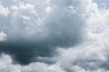 Fototapeta premium Cloudy sky on the horizon above the water. Nature background. Dramatic gray and white clouds in the blue sky.