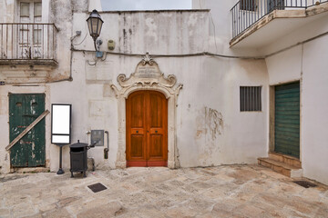 Vintage Trash Can Door and Touristic Sign in A Baroque Scenery in A Southern Italy Town Street