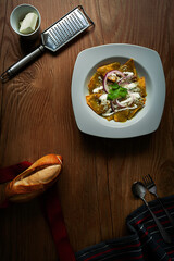 Platillo mexicano, chilaquiles verdes con estilo dark moody sobre mesa de madera con vista superior