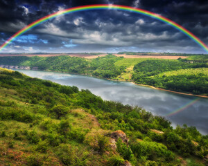 Fototapeta na wymiar colorful rainbow over the river canyon. spring morning