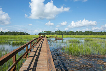 A dock goes out over the coastal salt marsh on the coast of South Carolina near Beaufort.