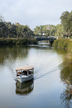 A small boat plies the canal in Palmetto Bluff, an exclusive community in South Carolina