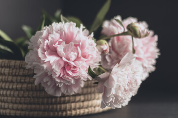 bouquet of peonies in a basket