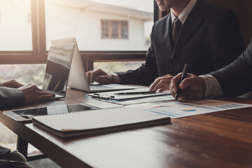 Business executives sit together in a business strategy planning meeting.