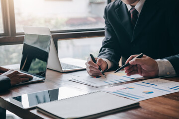 Business executives sit together in a business strategy planning meeting.