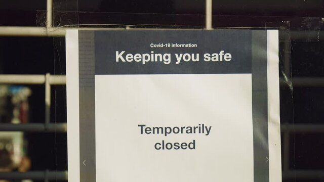 Temporary closed, keeping you safe: notice at the entrance door of a closed shop. Stores and shops are closed during lockdown, owners informing customers that the business is closed.