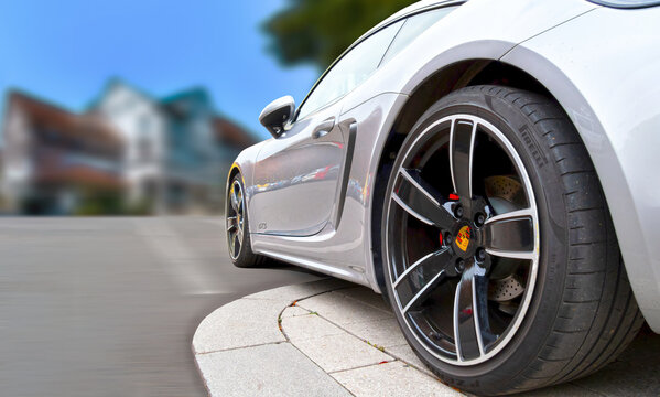 Porsche Carrera 911 Parked On The Street, Lower Side View With Original Rims And Tires Of Pirelli