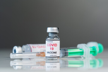 coronavirus covid-19 vaccine bottles and syringe injection