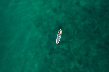 Man Paddle boarding on the ocean