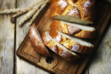 Selective focus. Fresh wheat bread on the board. Bread in slices.