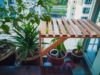 Kuala Lumpur, Malaysia - August 3, 2019: Wooden table in the balcony garden.