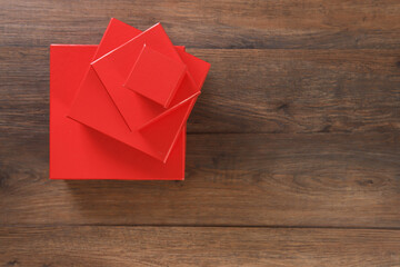 red gift boxes on wooden background with space