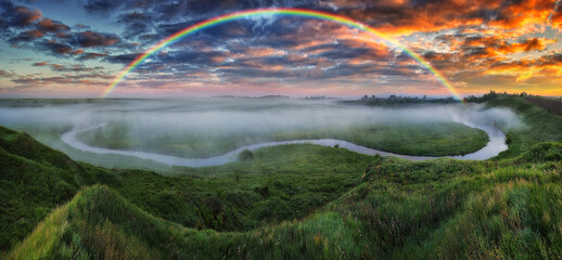 Landscape with a Rainbow on the River in Spring. colorful morning