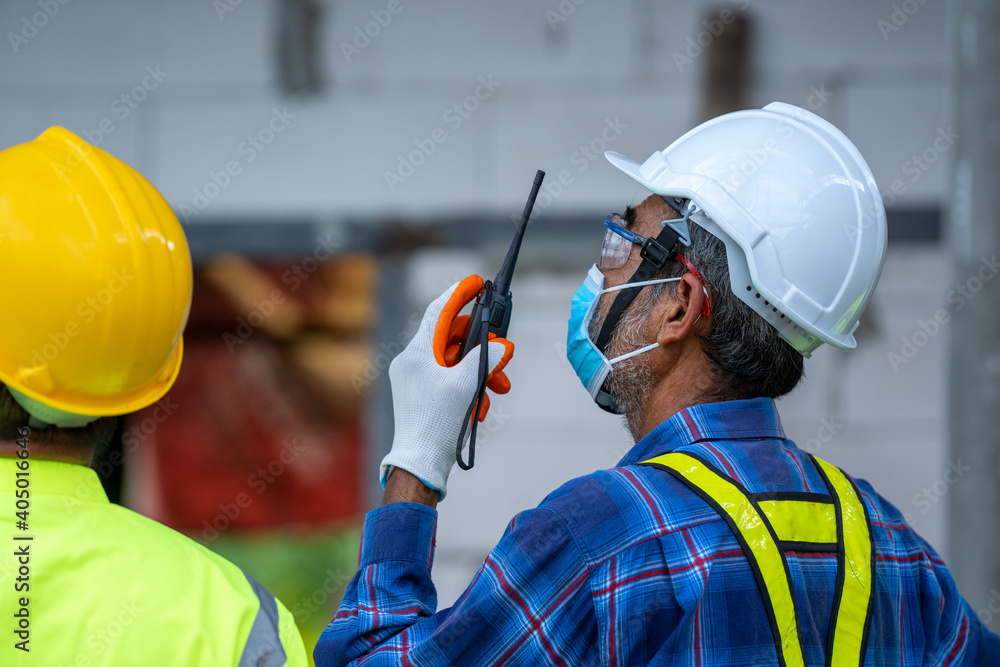 Aufkleber engineer wearing protective mask to protect against covid-19 and checking production process at the 