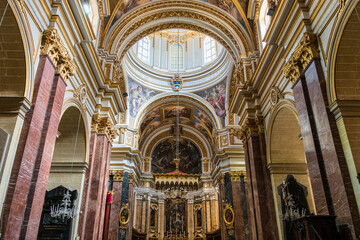 Fototapeta na wymiar Beautiful interior with paintings and decorations inside of Church in Valletta (or Il-Belt), the capital of the Mediterranean island nation of Malta