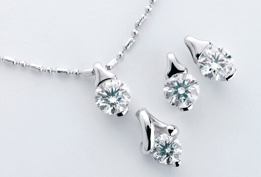 Close-up Of Necklace With Diamond Pendants Over White Background