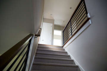 Modern staircase looking up with contemporary lines and railings