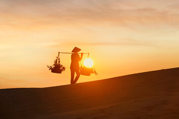 Asian woman Vietnam culture traditional dress on sandune during sunset ,traditional costume ,Muine...