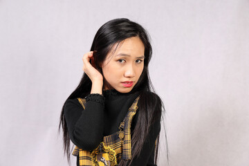 Young attractive southeast Asian woman posing facial expression crazy mad tongue sticking out bad...