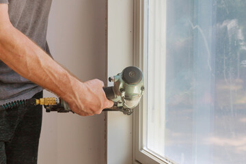Worker installing trim around a window