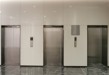 Three Elevators in looby office hall with luxury black polished marble floor and glass wall covering. Pictures for interior design.